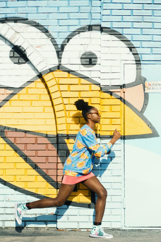 Woman Wearing Blue and Yellow Long-sleeved Top and Pink Skirt